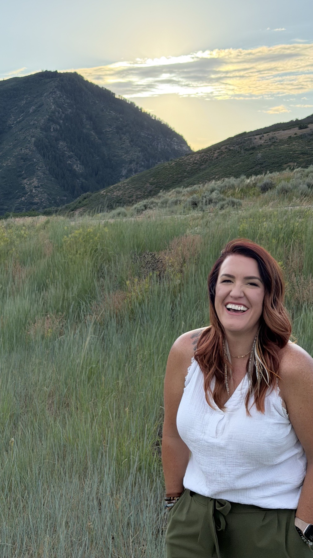 Hailey Lindberg smiling outdoors in the mountains of Northern Utah